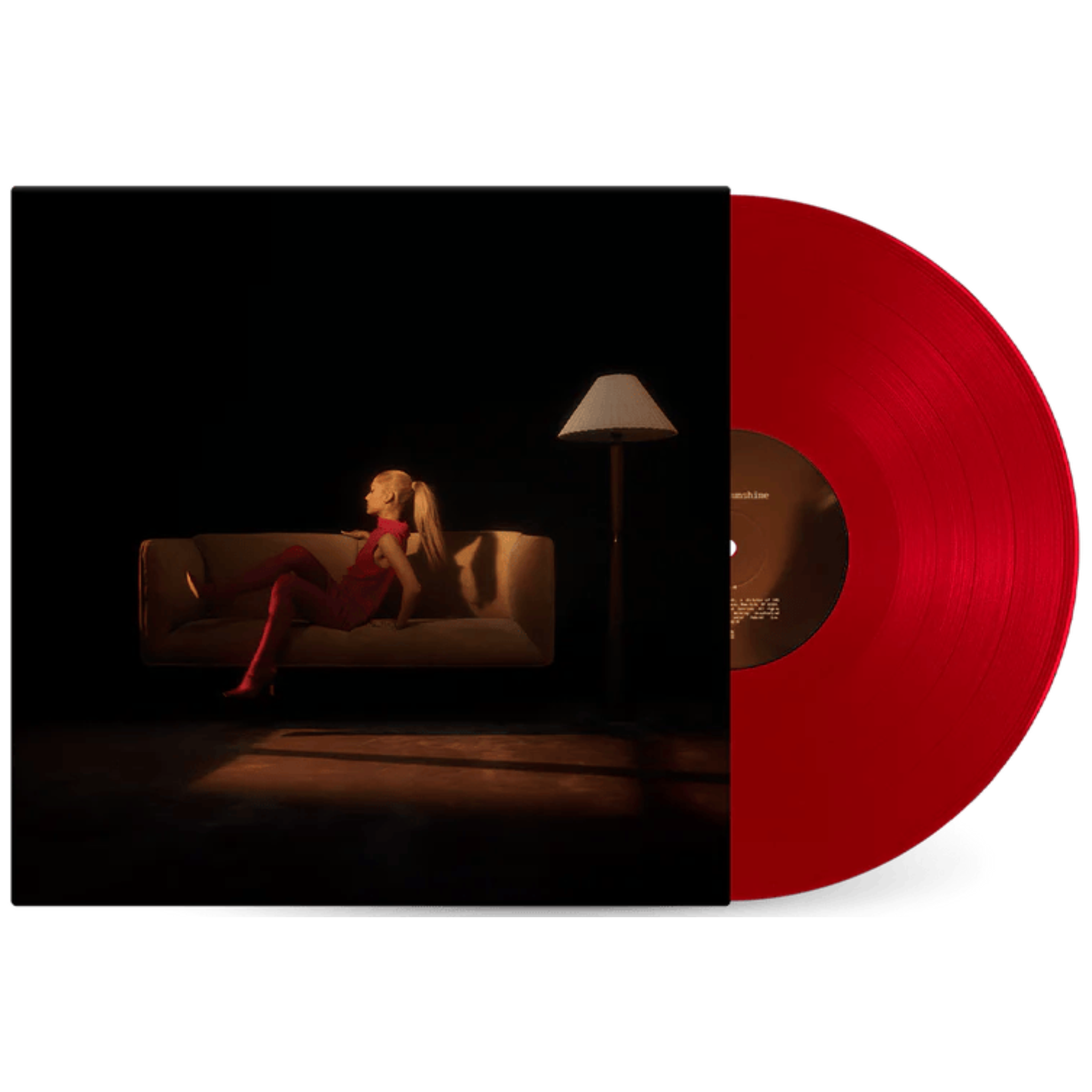 Vinyl record with a dark cover featuring a woman on a couch and a red disc.